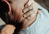 Is It Whiplash? 5 Warning Signs You Should Never Ignore Man with neck pain holding his neck in discomfort, conveying tension or stress.