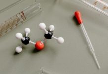 Cleaner Chemistry, Smarter Industry: The Rising Demand for Refined Ethanol Blends Close-up of laboratory equipment and molecular model on a flat surface.