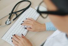 The Hidden Risks Of Telemedicine For Arizona Practitioners Under Regulatory Scrutiny Doctor typing on keyboard with stethoscope nearby