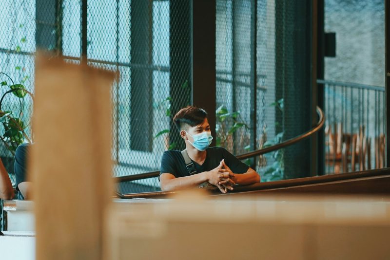 Photo by Rendy Novantino man in black t-shirt sitting on chair