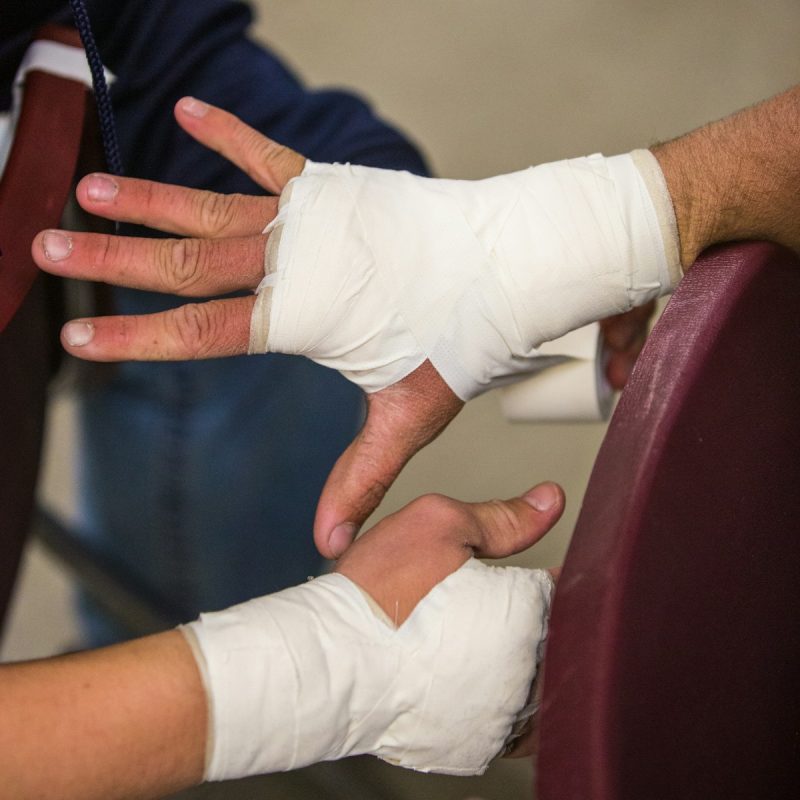 Photo by Daniel Lloyd Blunk-Fernández person in white gloves holding persons hand