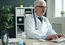 Harnessing AI-Driven Platform Ecosystems to Elevate Revenue Operations Doctor typing on computer in office