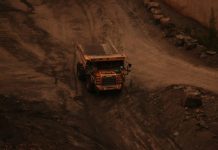 Why Sand Isn’t “Just Sand”: An Industrial Guide for Business Owners a dump truck driving down a dirt road