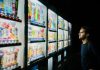 man on front of vending machines at nighttime