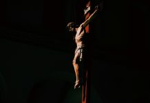 5 Ways to Encounter God This Year a statue of a man on a cross in the dark