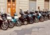 motor scooter lined parking area during daytime