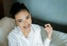 Why Does Quality Dental Braces Matter More Than Ever in Patient Care women's sitting on sofa wearing white dress shirt