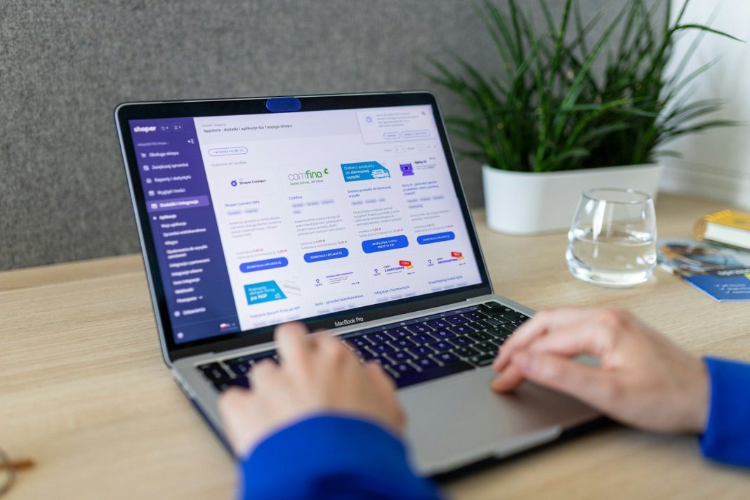 Photo by Shoper a person typing on a laptop on a table