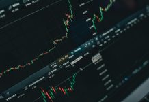 Why You Should Start Learning About the Stock Market Today, and How to Do It Effectively Close-up of stock market trading screen displaying financial growth and charts.