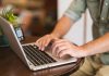 a man typing on a laptop