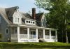 white and brown wooden house near green trees during daytime