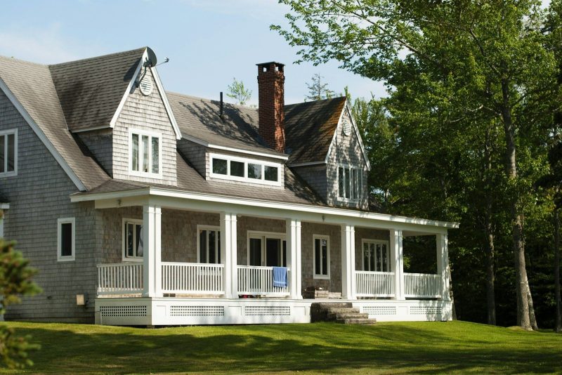 Photo by Aubrey Odom white and brown wooden house near green trees during daytime