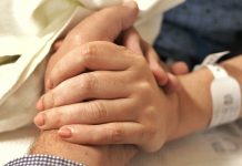 How Palliative Care Can Support Patients Living with Cancer a close up of a person holding the hand of another person