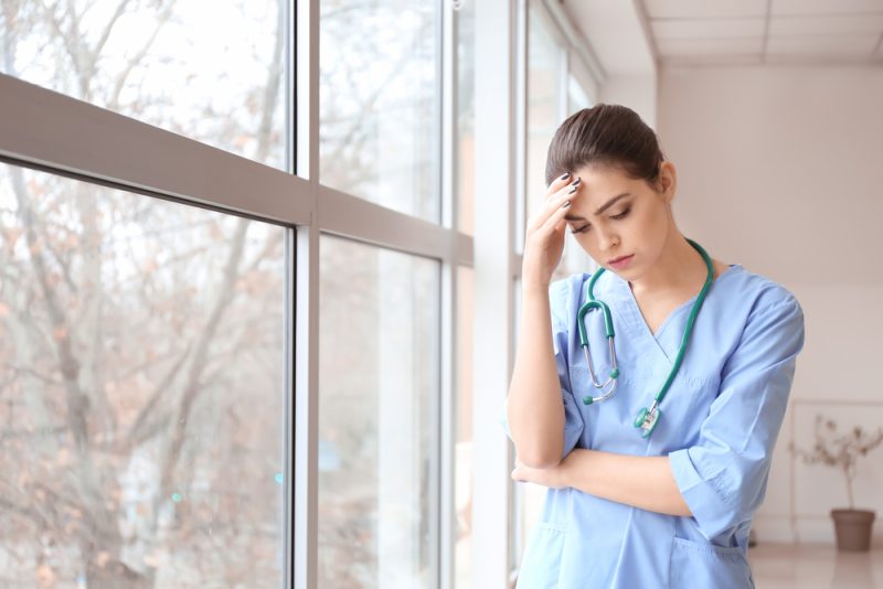 Depressed,Female,Doctor,Near,Window,In,Clinic