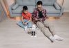 How Artificial Intelligence Is Quietly Redefining Everyday Life and Decision-Making Father and son bonding over robotics and technology at home, enjoying playful interaction with a robot.
