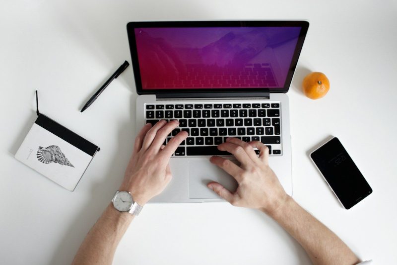 Photo by NordWood Themes person using laptop computer