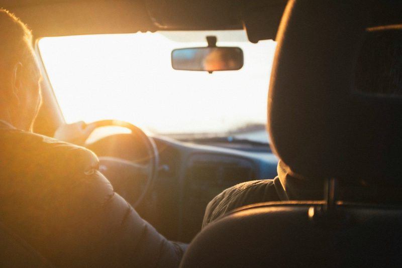 Photo by Darwin Vegher man driving car during golden hour