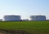 Why Is Oil Storage Facility Inspection Important for Business Continuity? Two large white storage tanks in a field