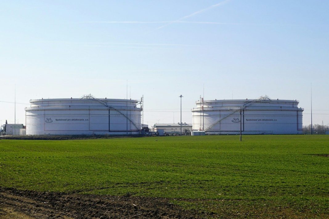 Photo by Energie-portal.sk Two large white storage tanks in a field
