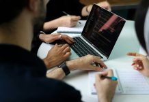 Can You Be Fired For Reporting Illegal Activity At Work? a group of people sitting around a laptop computer