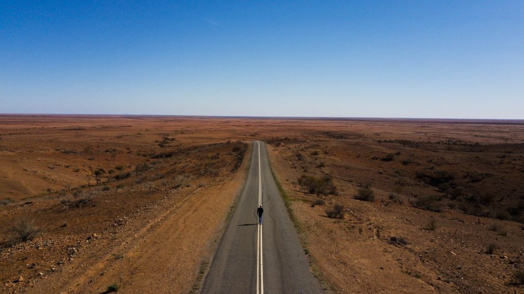 Photo by Dylan Shaw gray concrete road between brown field under blue sky during daytime