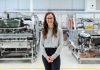 Why Manufacturing Consulting Is the Missing Step Between a Great Product and a Profitable Business woman in white long sleeve shirt and black pants wearing black framed eyeglasses