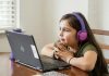 Key Benefits Of Joining Online English Classes in Mumbai For Better Communication Skills a little girl sitting at a table with a laptop