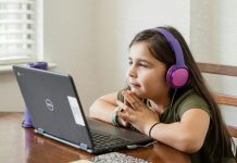 Key Benefits Of Joining Online English Classes in Mumbai For Better Communication Skills a little girl sitting at a table with a laptop