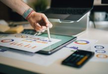 Debt Recovery Software In India: How Automated Mandates Are Replacing Field Agents person using stylus on tablet with charts