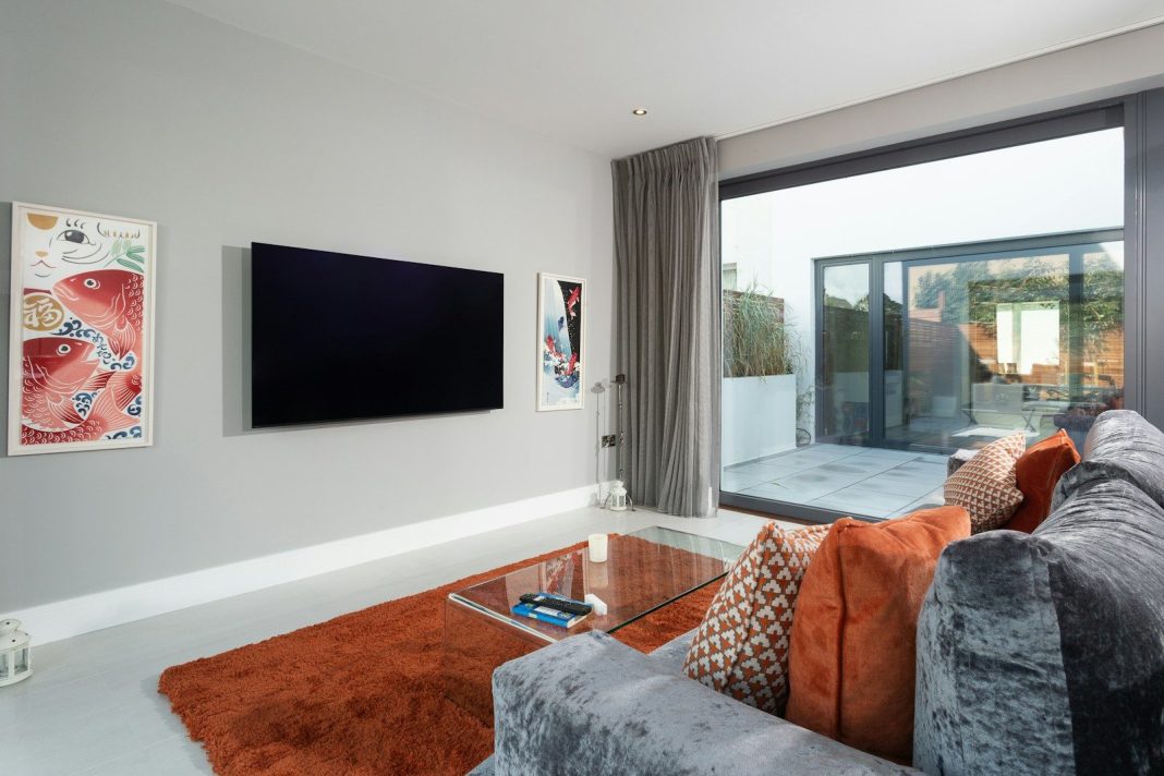 Photo by Tile Merchant Ireland a living room with a tv and couches