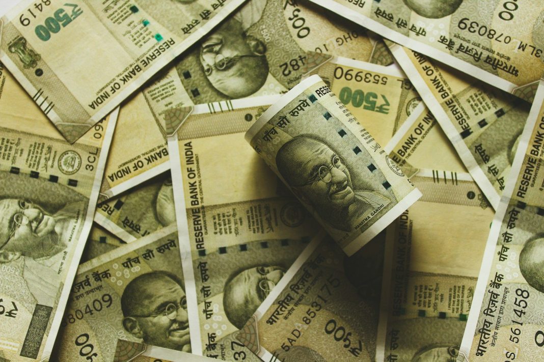 Photo by rupixen Indian rupee banknote lot close-up photography
