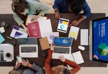 10 Leading B2B SEO Agencies Helping Businesses Generate More Qualified Leads A diverse team collaborating on digital marketing strategies at a desk, using laptops and tablets.