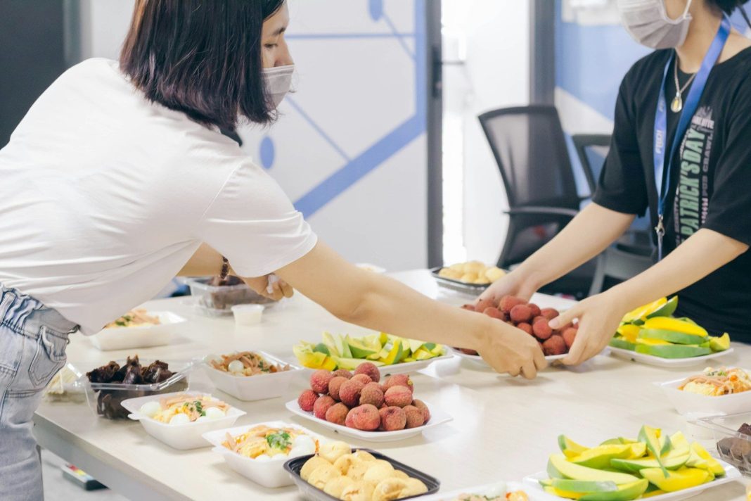 Photo by Nguyen Dang Hoang Nhu woman in white t-shirt slicing fruits on white table