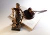 7 Things You Should Do Before Your First Court Appearance Statue of justice, gavel, and open book on table.
