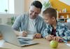 Father and son studying together at a desk