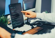 Steal Now, Decrypt Later: The Cyber Threat With a Very Long Memory A programmer working on code with a laptop and monitor setup in an office.