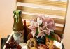 Wooden crate filled with food, flowers, and drink