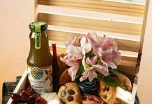 Celebrating Life’s Moments in London with Hamper Lounge Hampers Wooden crate filled with food, flowers, and drink