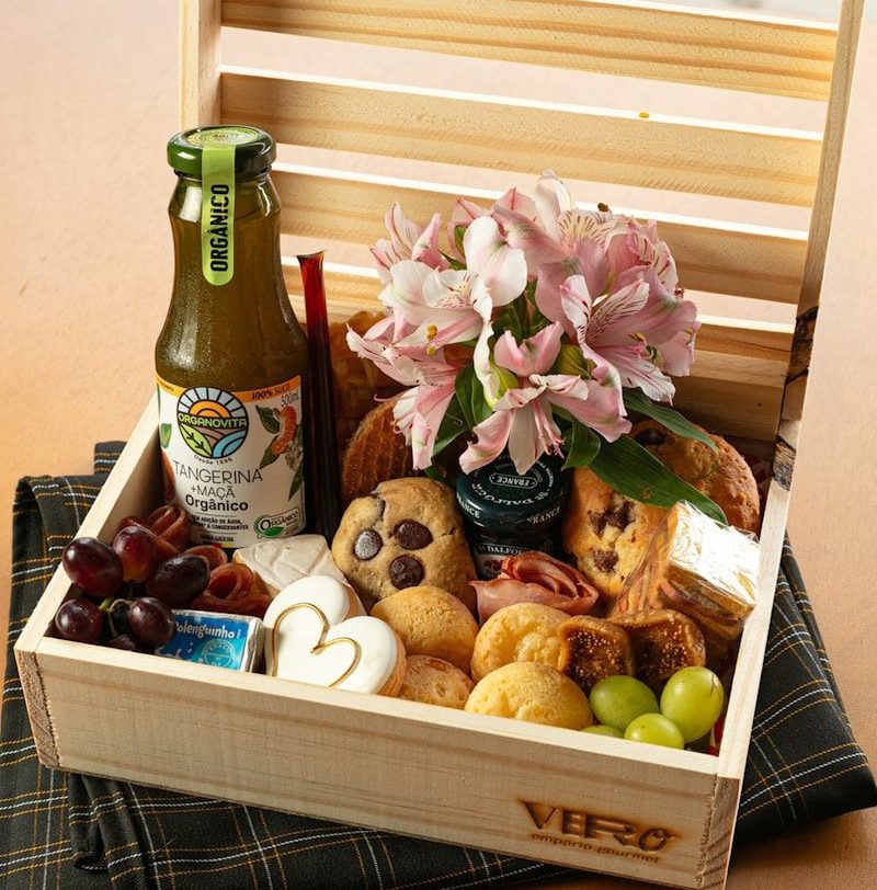 Photo by Rafael Pedroso Wooden crate filled with food, flowers, and drink