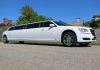 a white limo parked on the side of a road