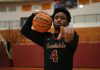 The Evolution of Basketball IQ and Strategic Athletic Thinking a man holding a basketball in a gym