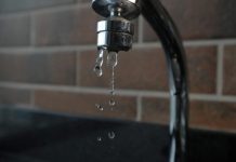 Why Does My Small Business Water Bill Keep Going Up When Nothing Has Changed? a faucet with water running from it's spout