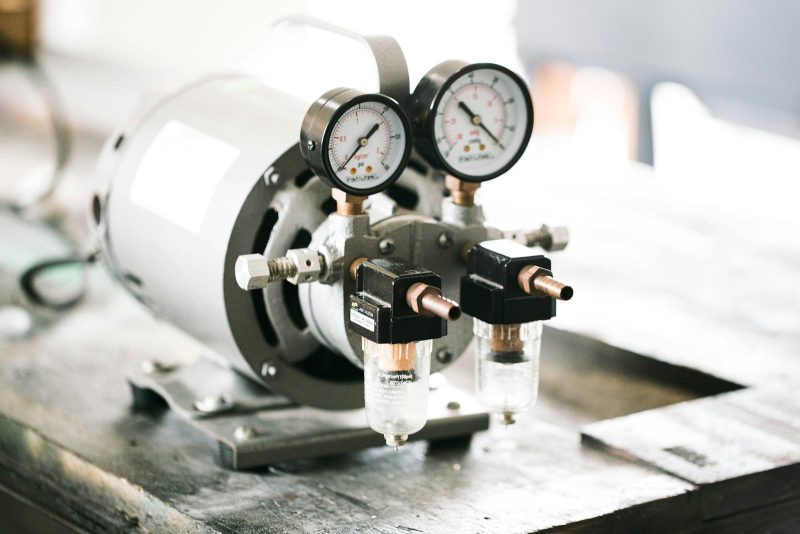 Photo by Jonathan Castañeda a couple of gauges sitting on top of a table