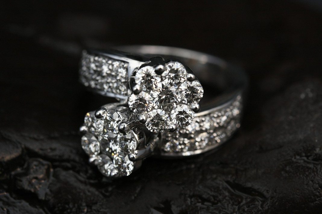 Photo by engin akyurt silver diamond studded ring on black surface