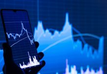 How to Trade Futures: The Ultimate Guide to Market Depth and Order Flow a person holding a cell phone in front of a stock chart