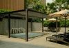 Enhancing Exterior Architecture: Why Invest in a Premium Solarlux Canopy? Outdoor spa area with lounge chairs and umbrellas