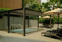 Enhancing Exterior Architecture: Why Invest in a Premium Solarlux Canopy? Outdoor spa area with lounge chairs and umbrellas