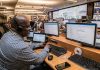 How Forward-Thinking Manufacturers Are Eliminating Costly Unplanned Downtime man in black and white checkered dress shirt using computer