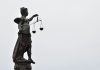 A statue of lady justice holding a scale of justice
