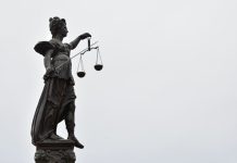 The Grand Jury Subpoena for Your Calendar: Why Federal Investigators Now Start With Scheduling Metadata A statue of lady justice holding a scale of justice